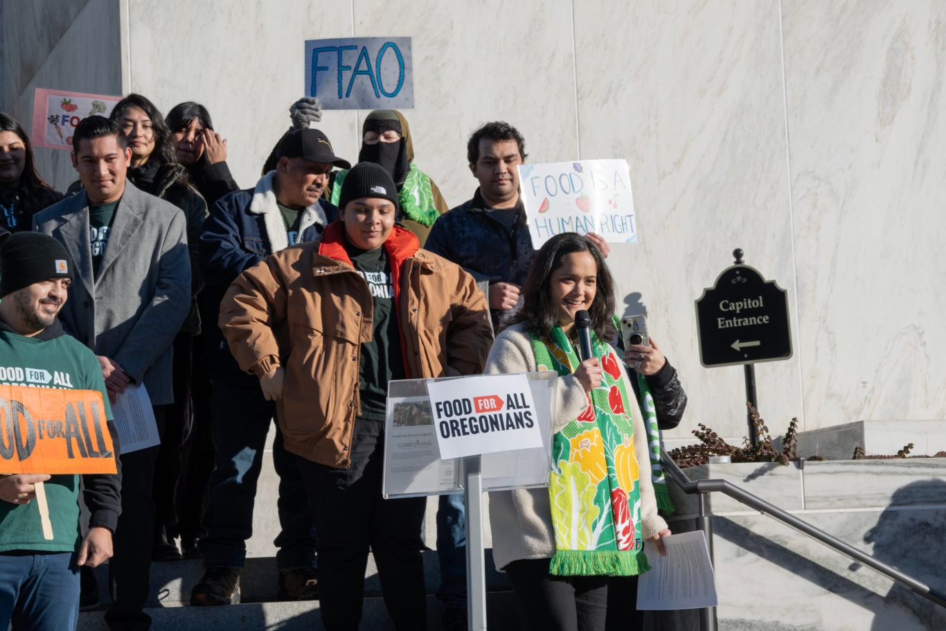 Andrea Williams speaks on the Oregon State Capitol steps, joined by advocates, delivering the 2025 State of Hunger Address and urging support for the Food for All Oregonians bill (SB 611).